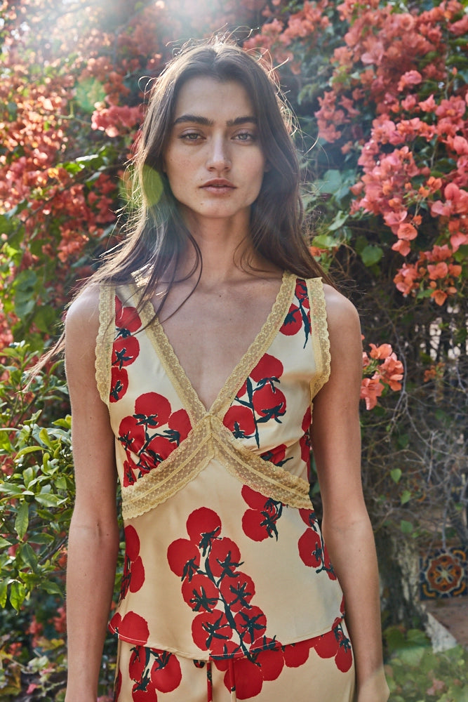 Woman wearing a floral dress with a garden background