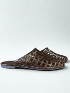 Brown woven sandals on a white background