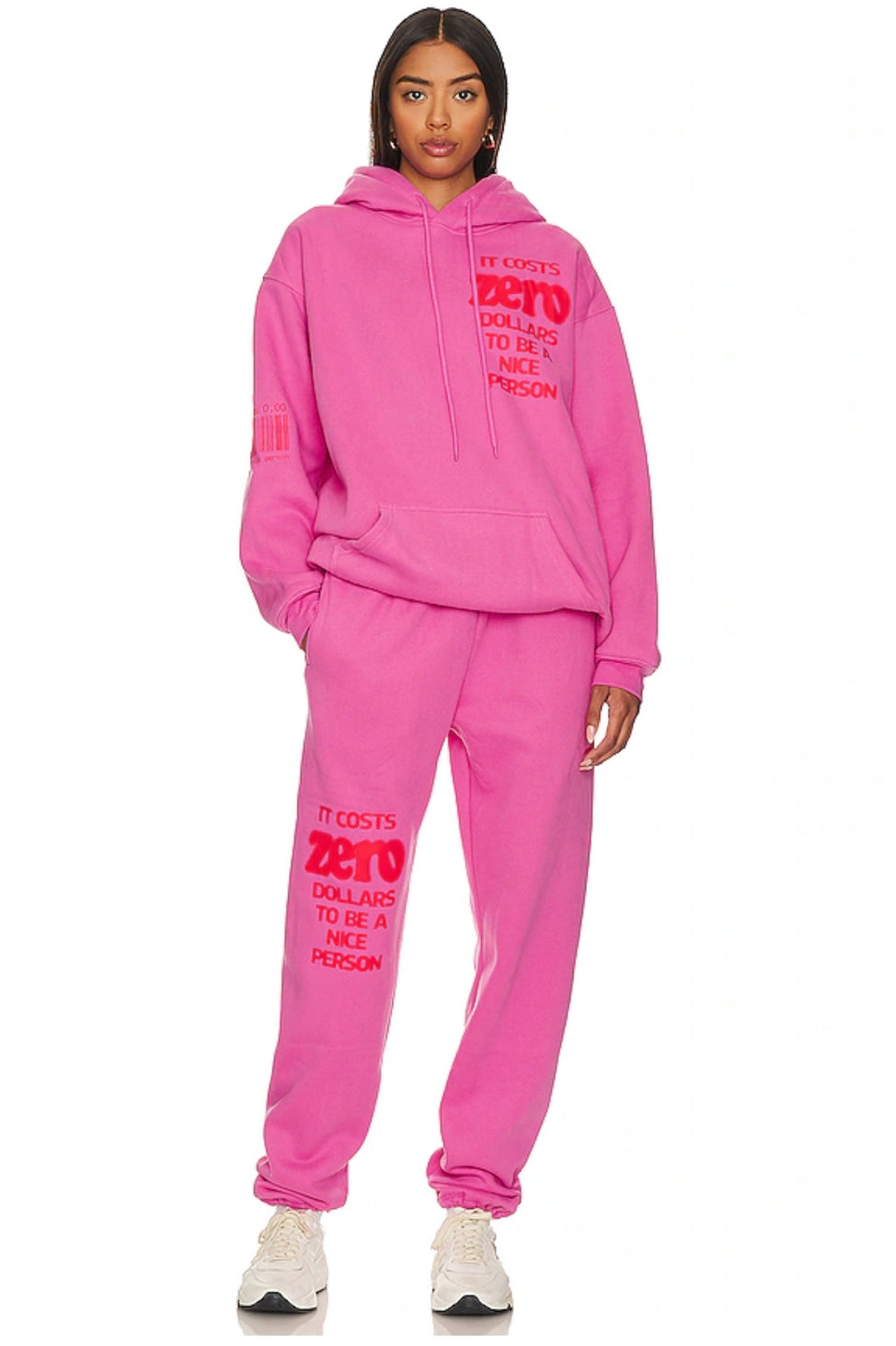 Person wearing a pink hoodie and pants set with text on a white background