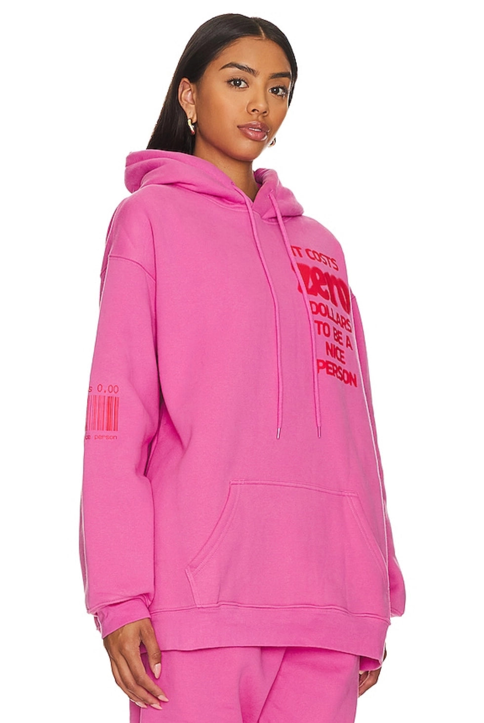 Person wearing a pink hoodie with text on a white background