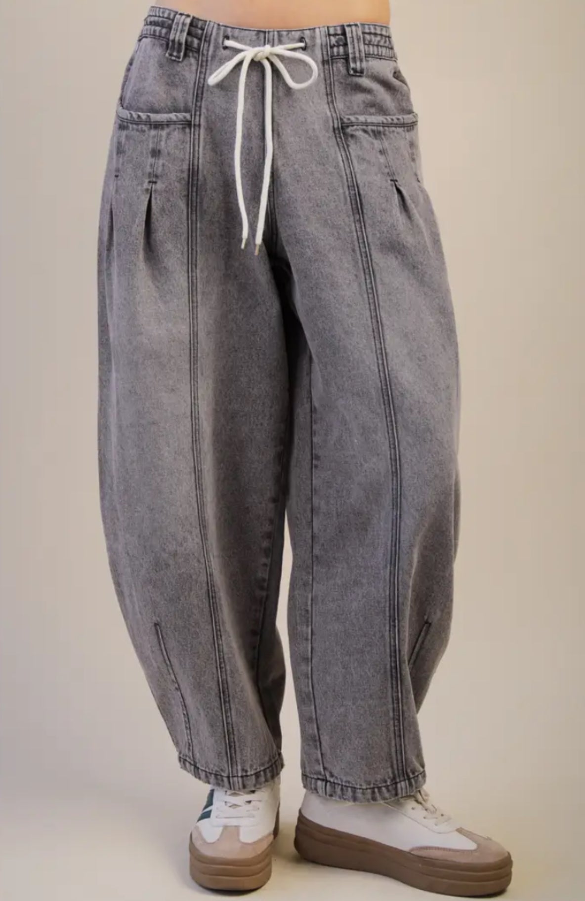 Gray jeans with a drawstring on a beige background