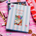 Pajama Party puzzle box on a pink surface with puzzle pieces and snacks.
