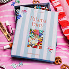 Pajama Party puzzle box on a pink surface with puzzle pieces and snacks.